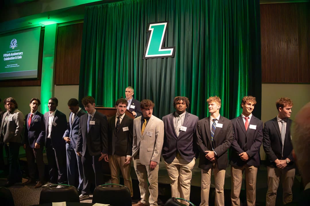 The current squad lined up to welcome the room