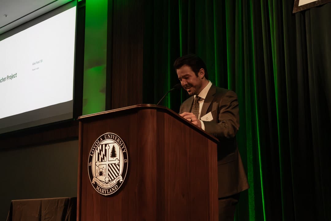 Alex Fossi '16 at the podium for the Bleacher Project