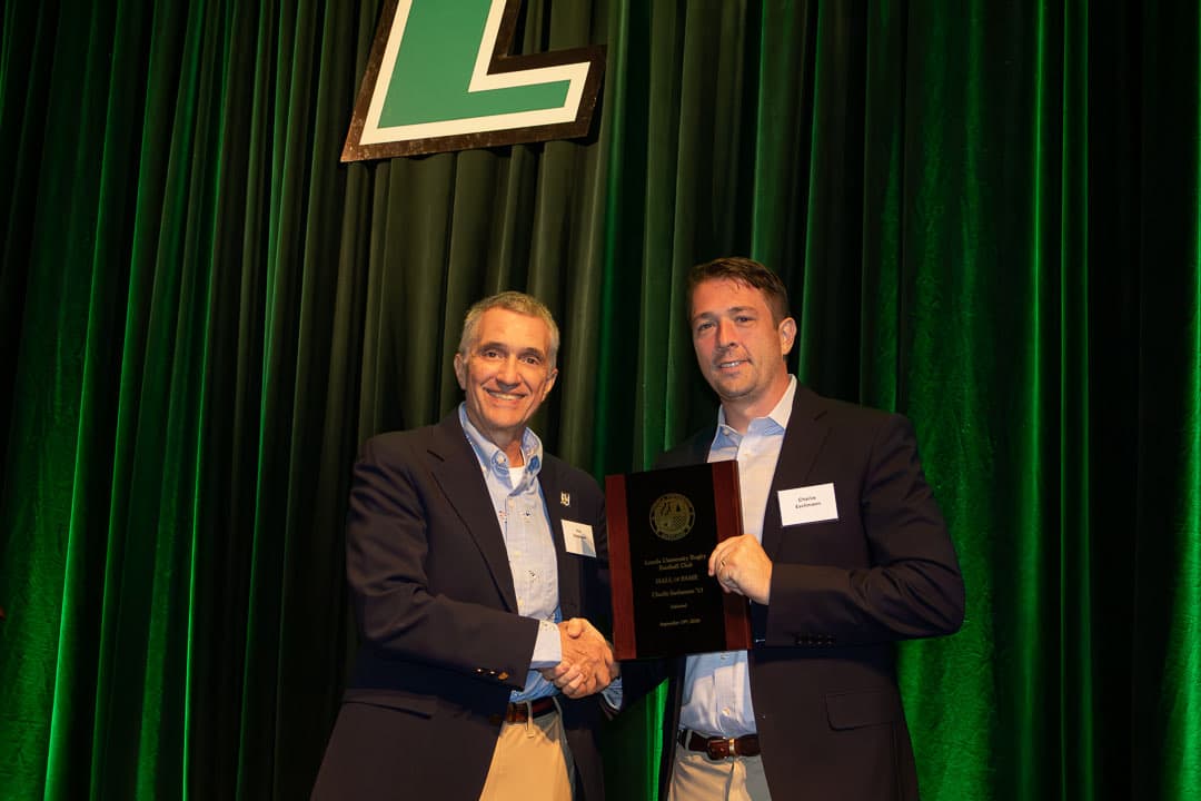 Charlie Eschmann '13 receiving his Hall of Fame plaque