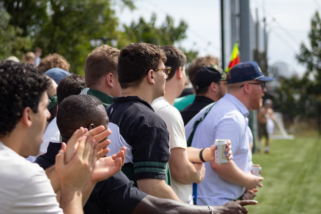 Alumni cheering from the sideline