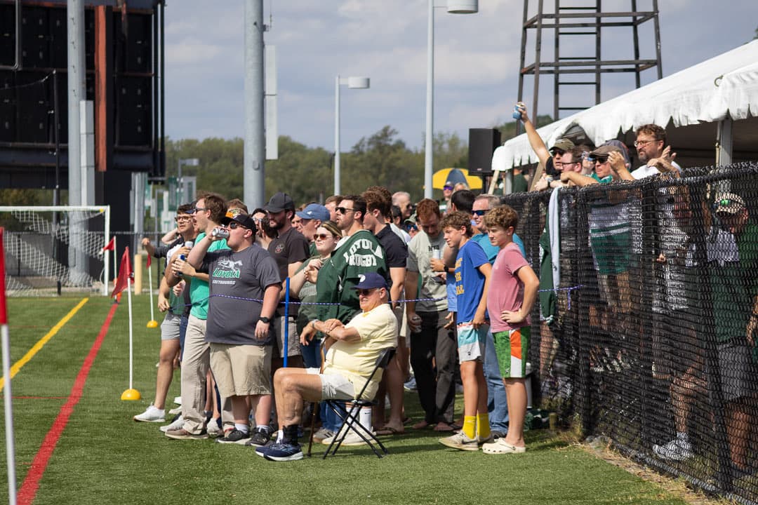 Watching from the fence, three deep