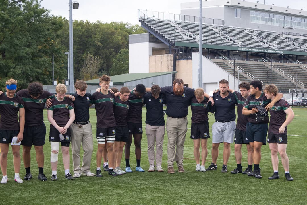 Players standing arm in arm