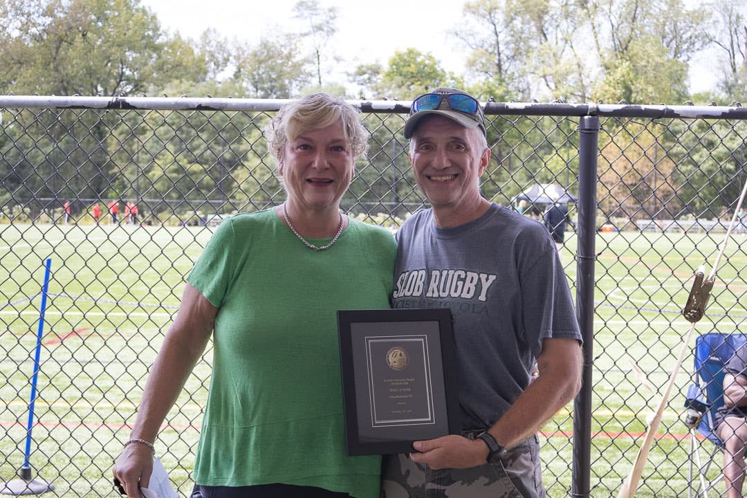 Accepting a plaque on the family's behalf